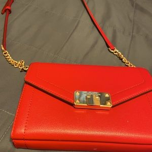 Beautiful MK purse with gold buckle and chain on strap.